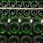 Rows of bottles aging at Cantillon